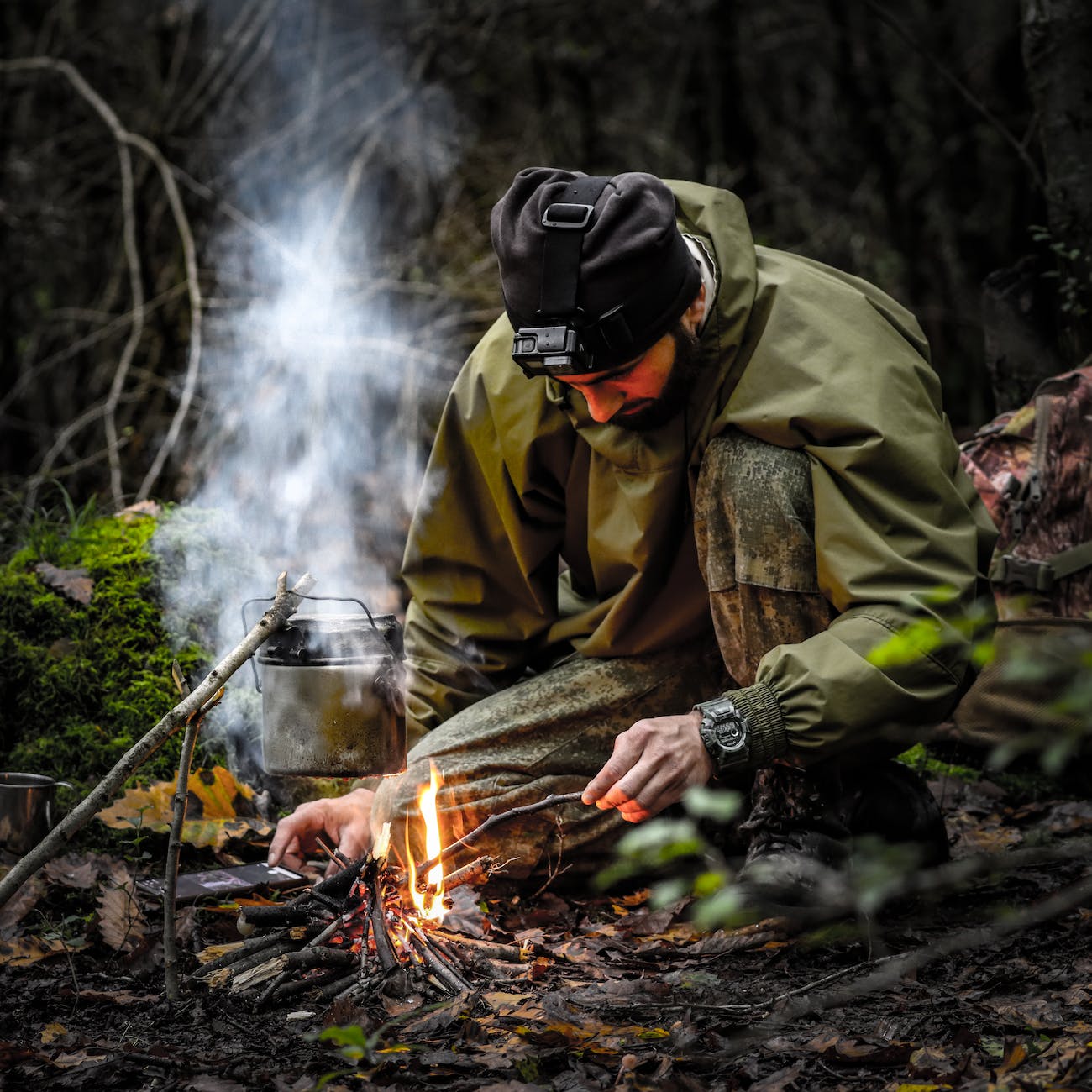 kneeling man starting fire in a fireplace