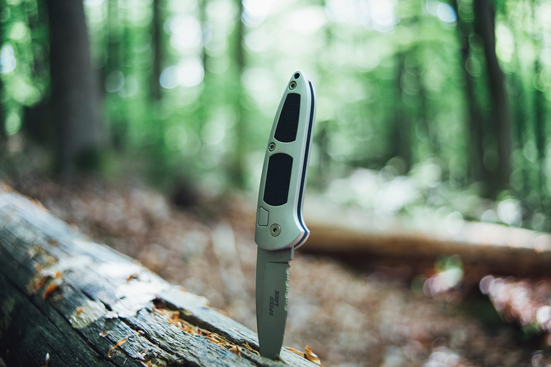 a silver hunting jack knife on the wood